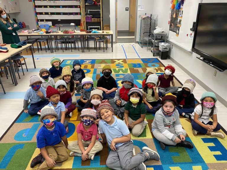 DMKA kindergartners wearing winter hats made by the RLC Knit & Crochet group, photo 5 of 6